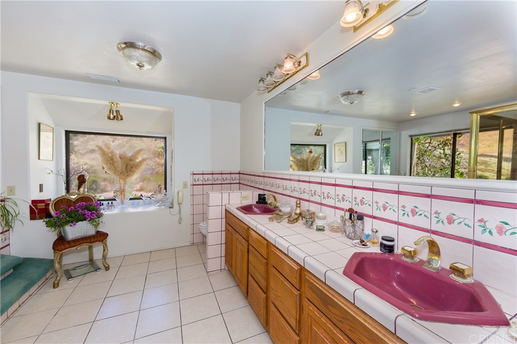 38833 Gorman Post Road Lebec, CA 93243 - Photo 25 of 55 a bathroom with a double vanity sink mirror and bathtub
