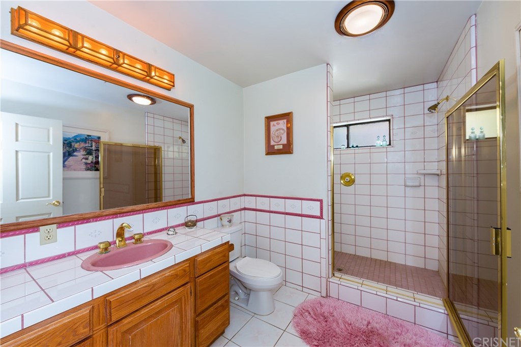 38833 Gorman Post Road Lebec, CA 93243 - Photo 28 of 55 a bathroom with a sink mirror vanity and toilet