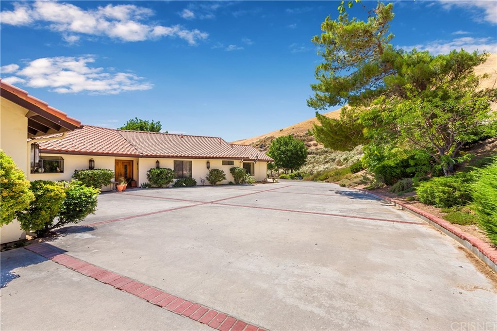 38833 Gorman Post Road Lebec, CA 93243 - Photo 3 of 55 a front view of a house with a yard and a garage