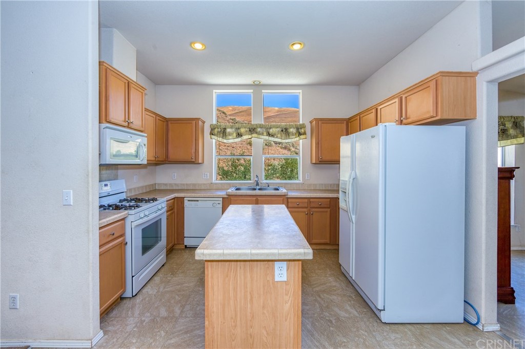 38833 Gorman Post Road Lebec, CA 93243 - Photo 36 of 55 a kitchen with stainless steel appliances granite countertop a refrigerator and a stove top oven