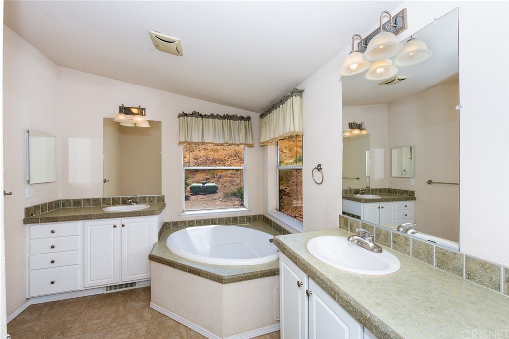 38833 Gorman Post Road Lebec, CA 93243 - Photo 43 of 55 a bathroom with a granite countertop sink mirror and bathtub