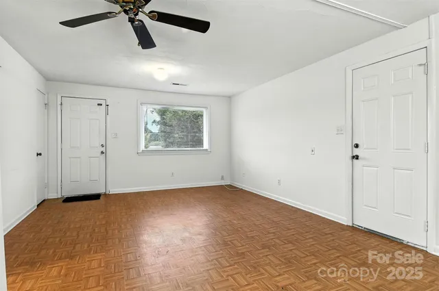 a view of room with ceiling fan and window