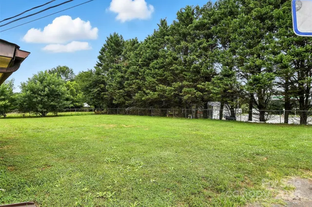 a view of a field of grass and trees