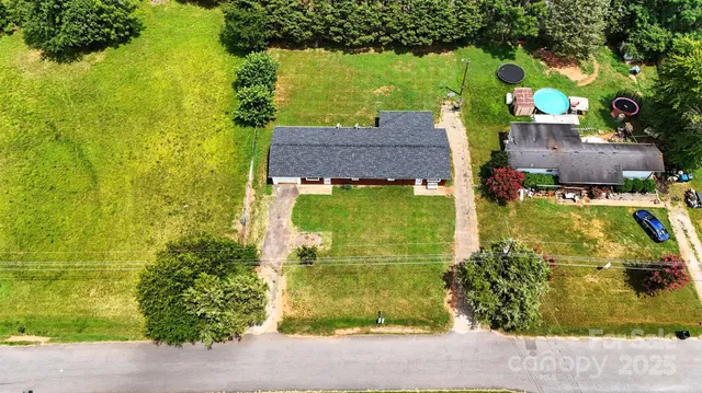 a aerial view of a house with a yard basket ball court and outdoor seating