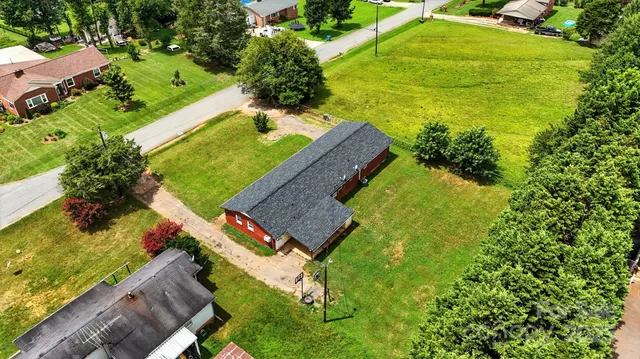 an aerial view of a house with a yard basket ball court and outdoor seating