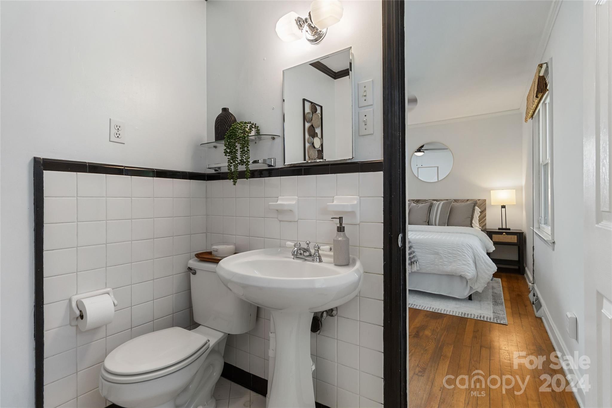 4346 Applegate Road Charlotte, NC 28209 - Photo 19 of 35 a bathroom with a sink toilet and a mirror