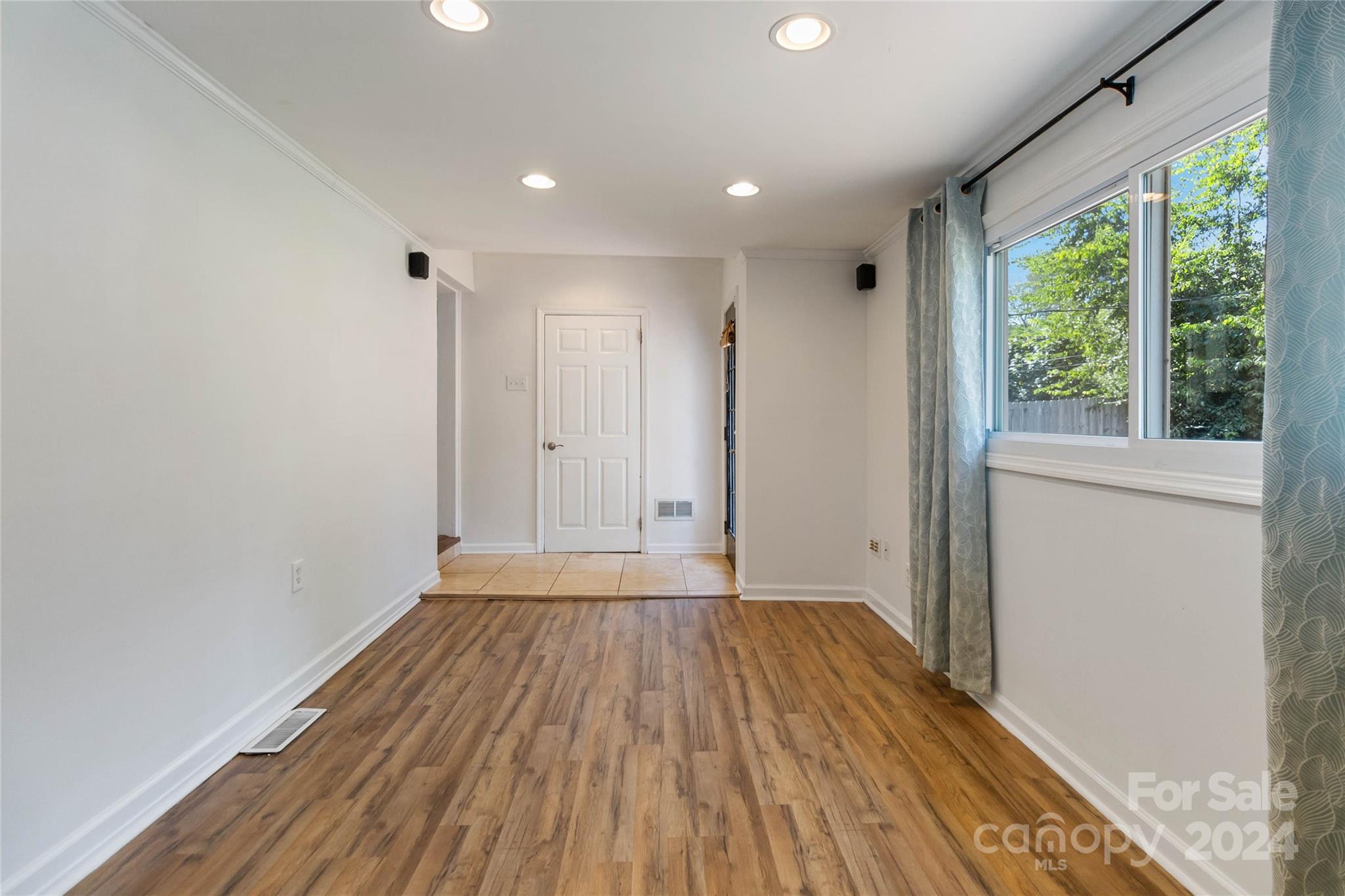 4346 Applegate Road Charlotte, NC 28209 - Photo 25 of 35 a view of an empty room with wooden floor and a window