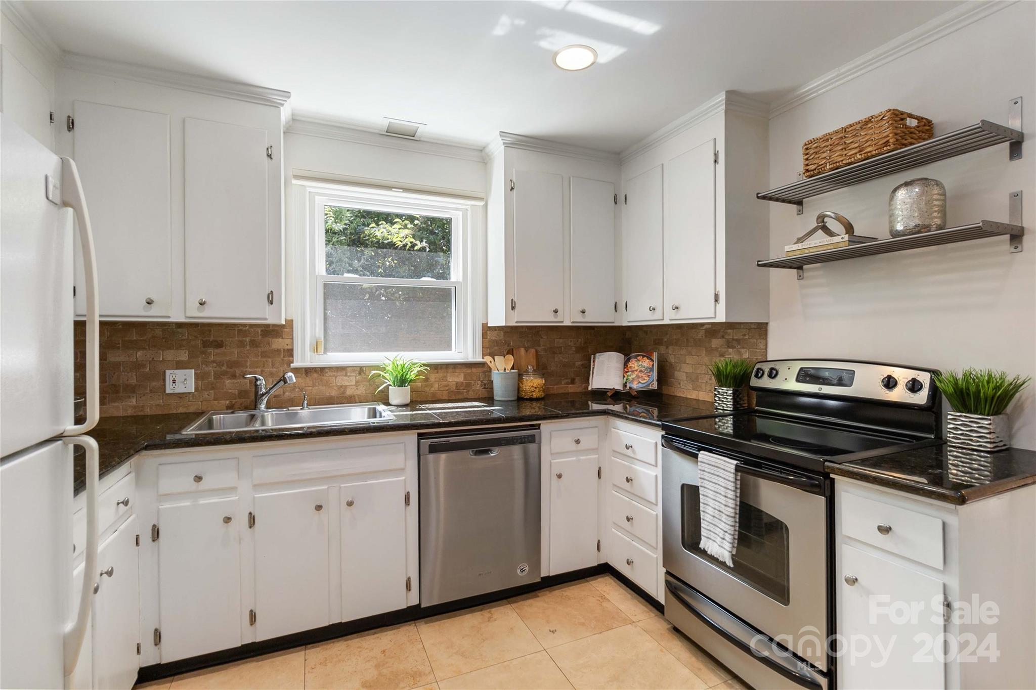 4346 Applegate Road Charlotte, NC 28209 - Photo 10 of 35 a kitchen with cabinets appliances a sink and a window