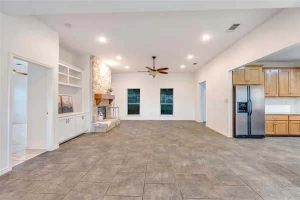 a view of an empty room with a fireplace