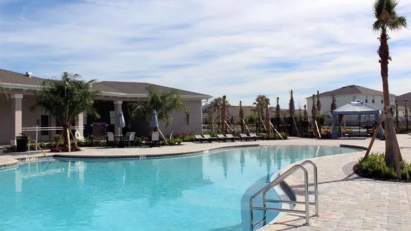 a view of a patio with swimming pool table and chairs