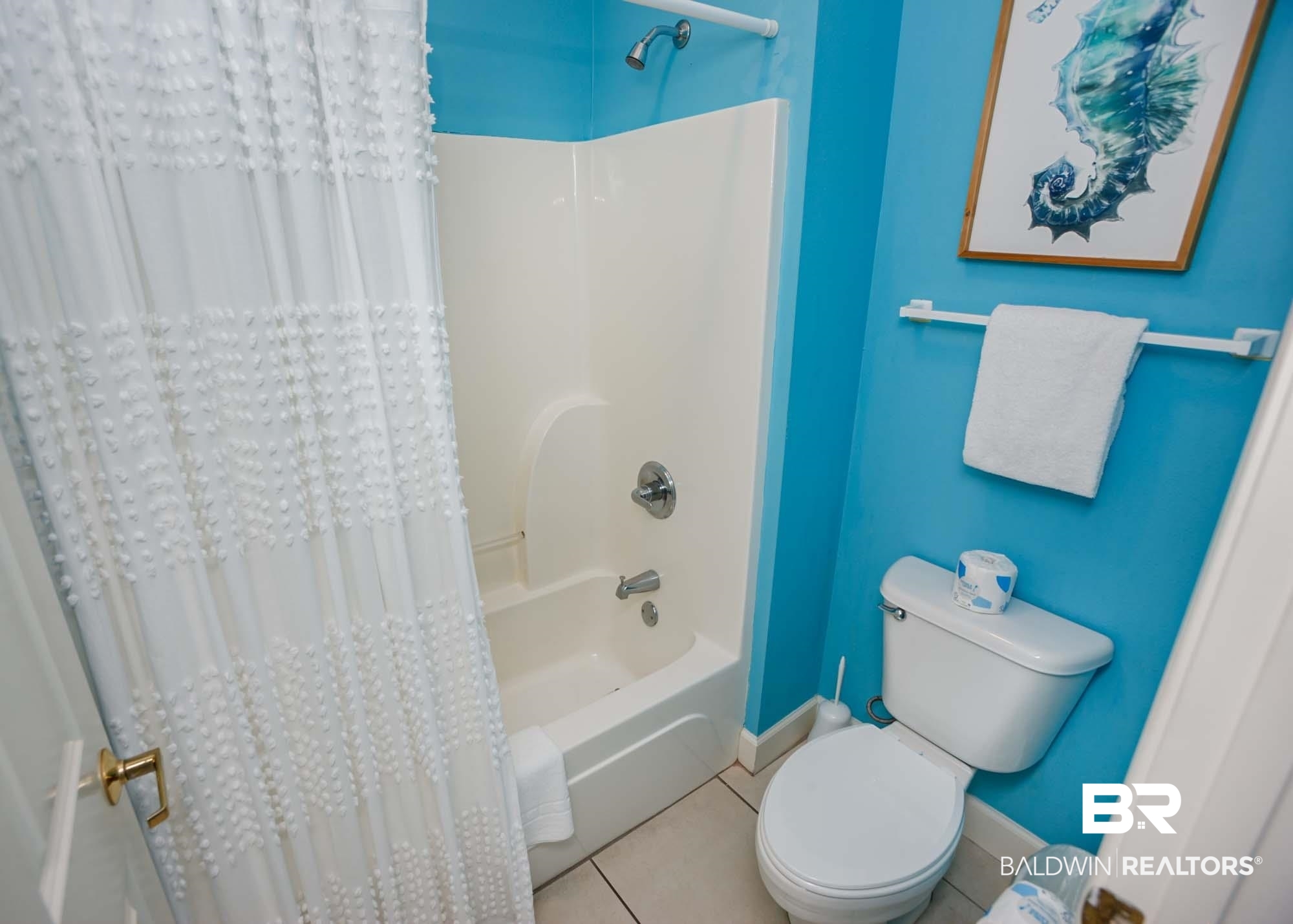 28910 Perdido Beach Boulevard, Unit 4B Orange Beach, AL 36561 - Photo 38 of 48 Bathroom featuring baseboards, shower / bathtub combination with curtain, toilet, and tile patterned flooring