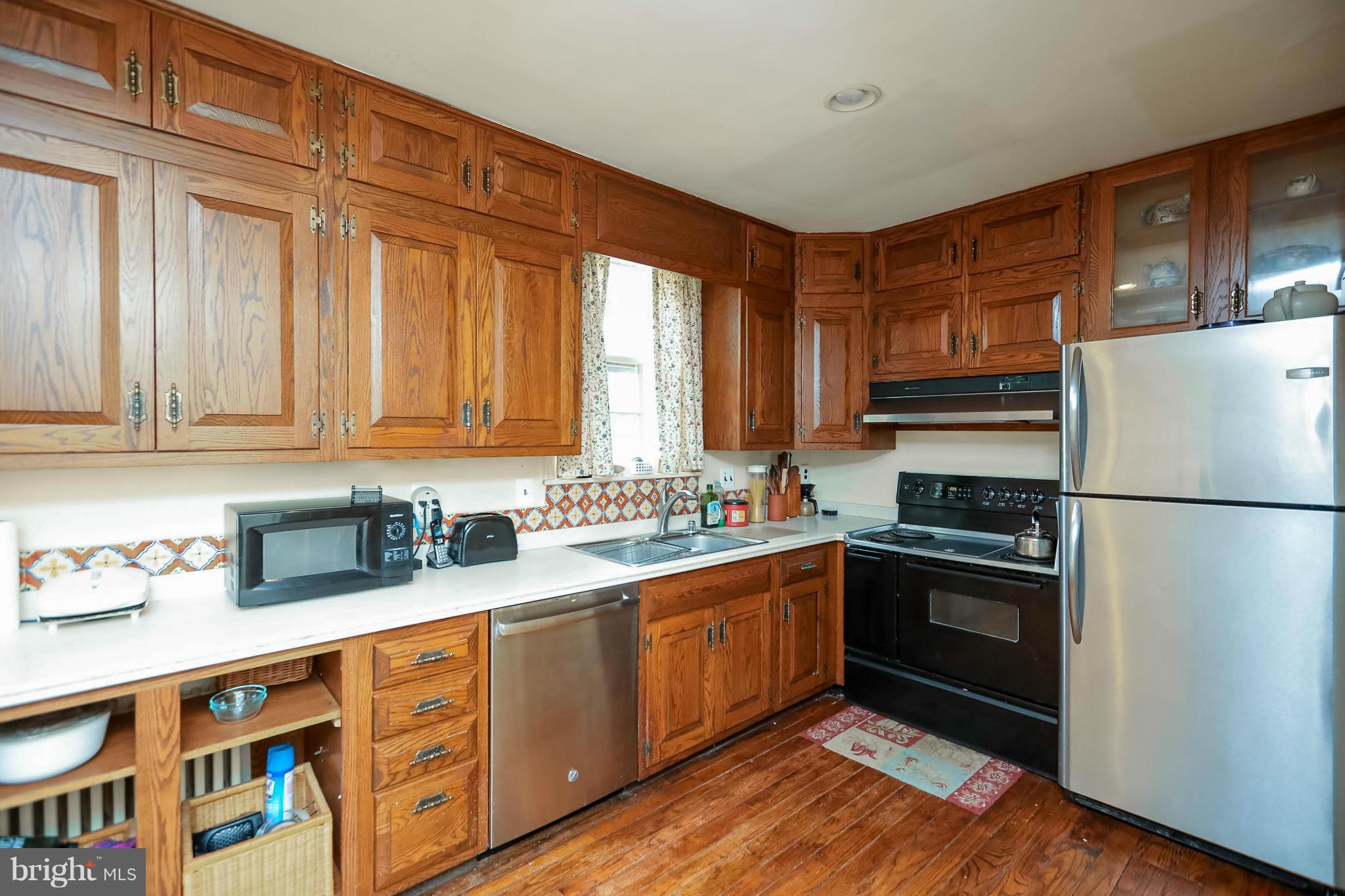 2801 Ridge Rd Drive Alexandria, VA 22302 - Photo 12 of 25 a kitchen with stainless steel appliances granite countertop a refrigerator sink and cabinets