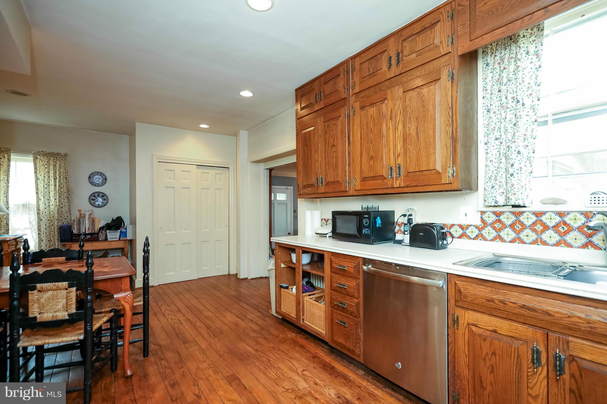 2801 Ridge Rd Drive Alexandria, VA 22302 - Photo 13 of 25 a kitchen with stainless steel appliances granite countertop wooden cabinets a dining table and chairs
