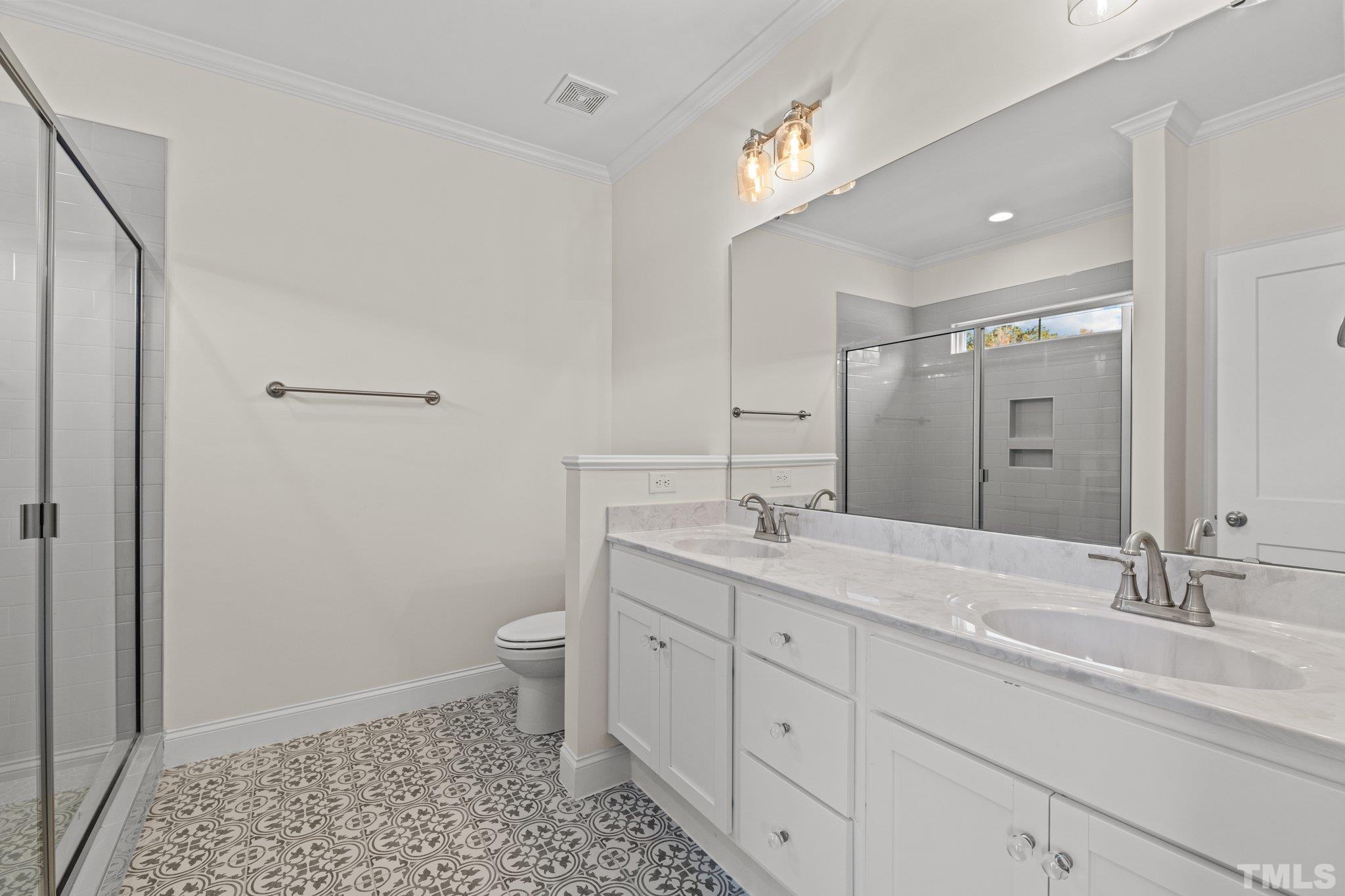 454 Pine Ridge Road Zebulon, NC 27597 - Photo 14 of 42 a bathroom with a double vanity sink toilet and a mirror