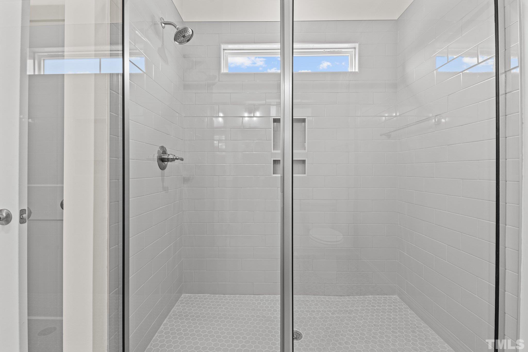 454 Pine Ridge Road Zebulon, NC 27597 - Photo 15 of 42 a bathroom with a glass shower door