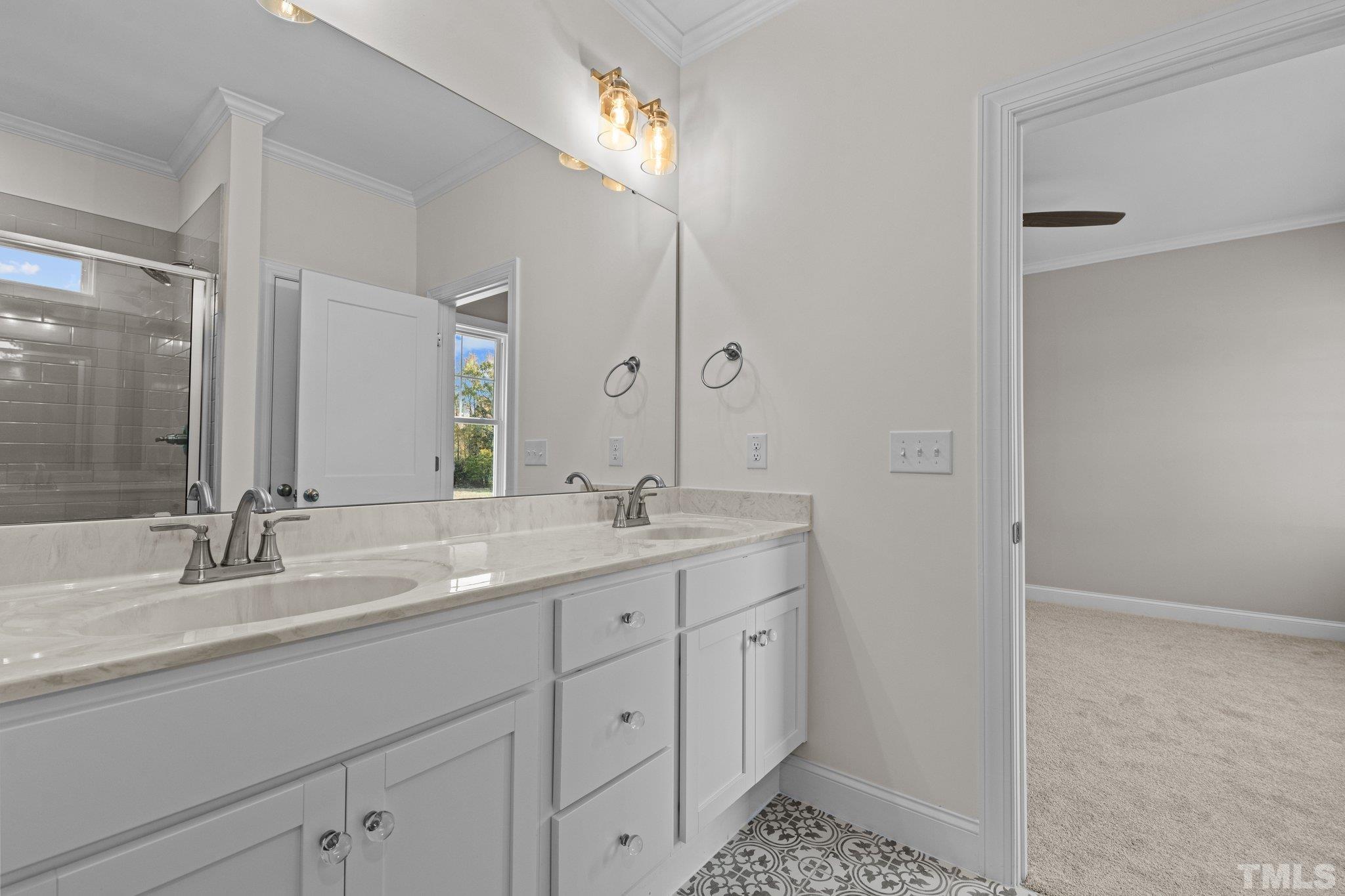 454 Pine Ridge Road Zebulon, NC 27597 - Photo 16 of 42 a bathroom with a double vanity sink and a mirror
