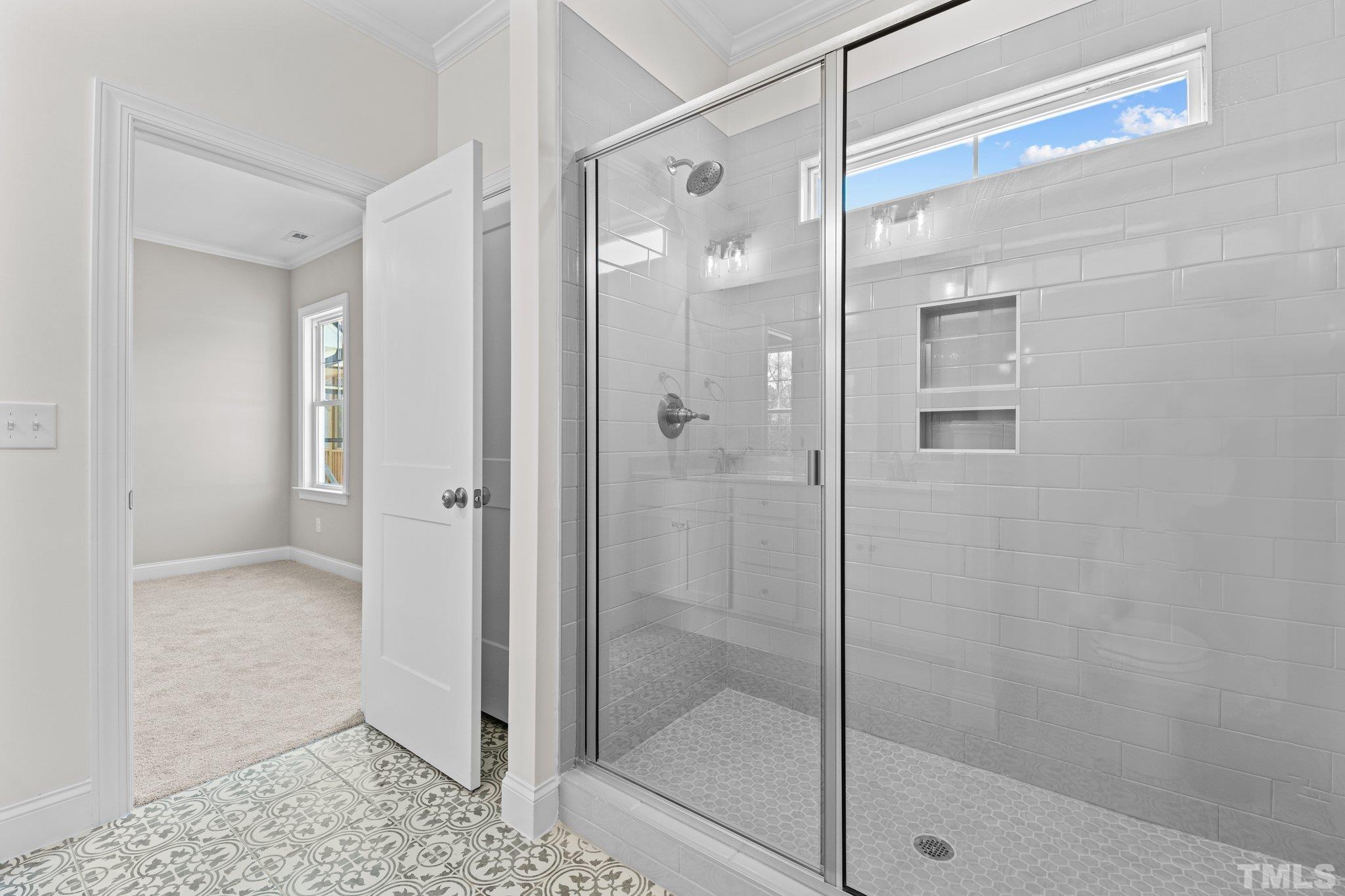 454 Pine Ridge Road Zebulon, NC 27597 - Photo 17 of 42 a bathroom with a glass shower door