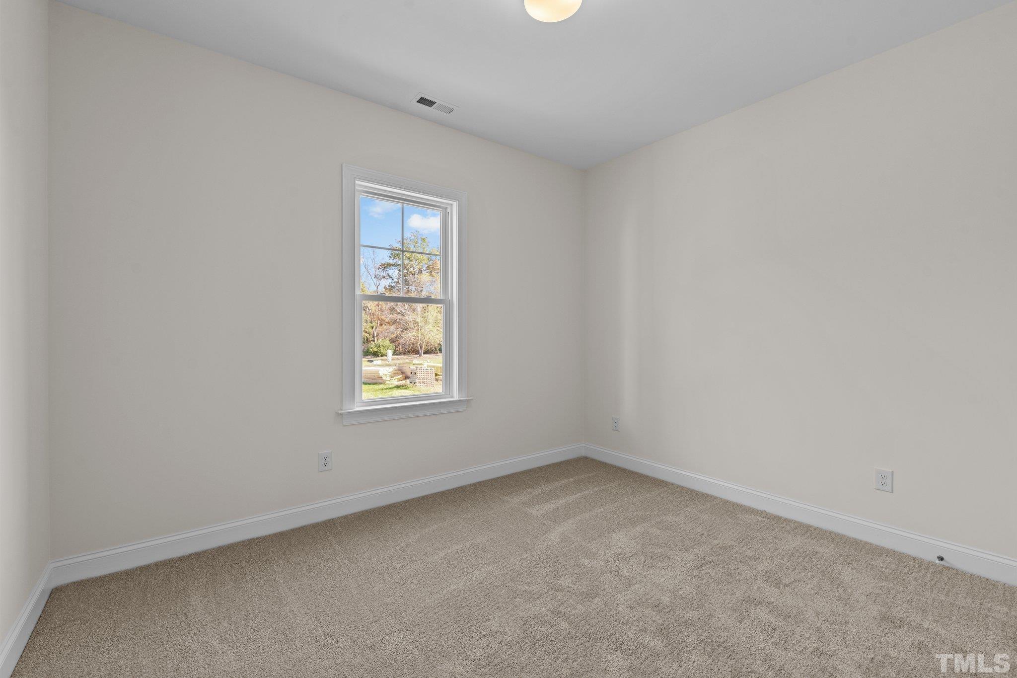 454 Pine Ridge Road Zebulon, NC 27597 - Photo 20 of 42 an empty room with a window