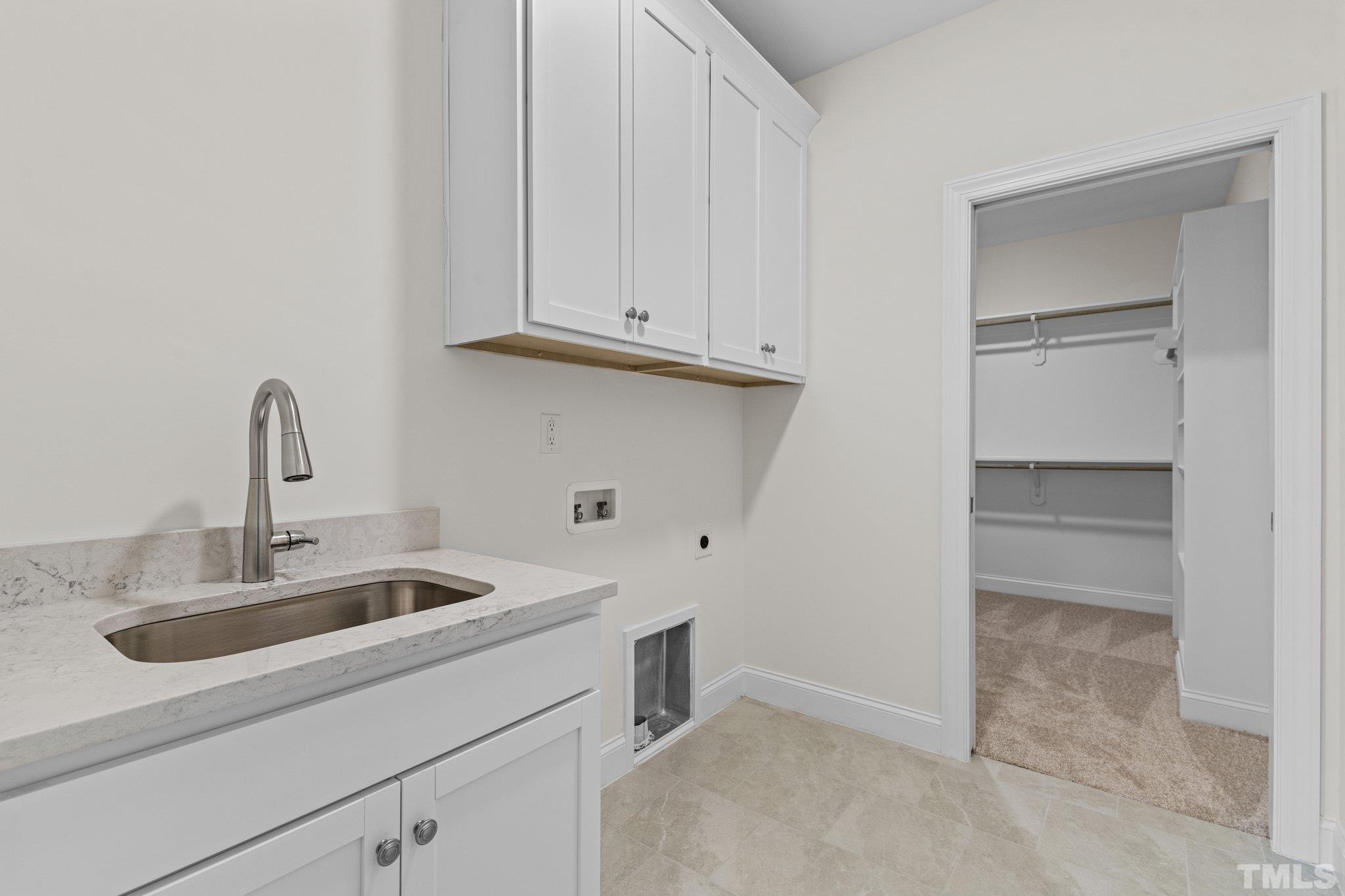 454 Pine Ridge Road Zebulon, NC 27597 - Photo 25 of 42 a kitchen with white cabinets and a sink