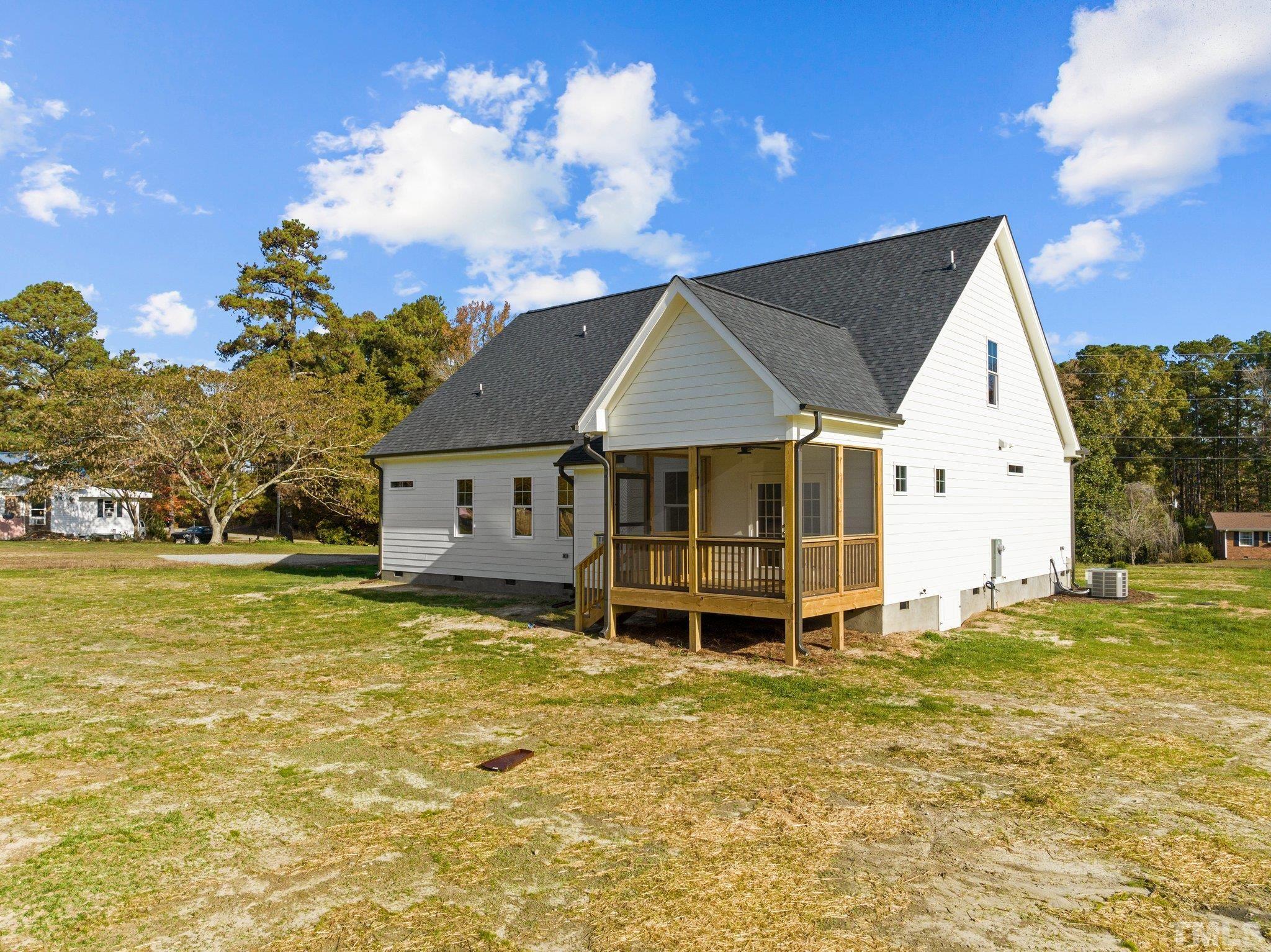 454 Pine Ridge Road Zebulon, NC 27597 - Photo 29 of 42 a house that has a big yard with wooden fence