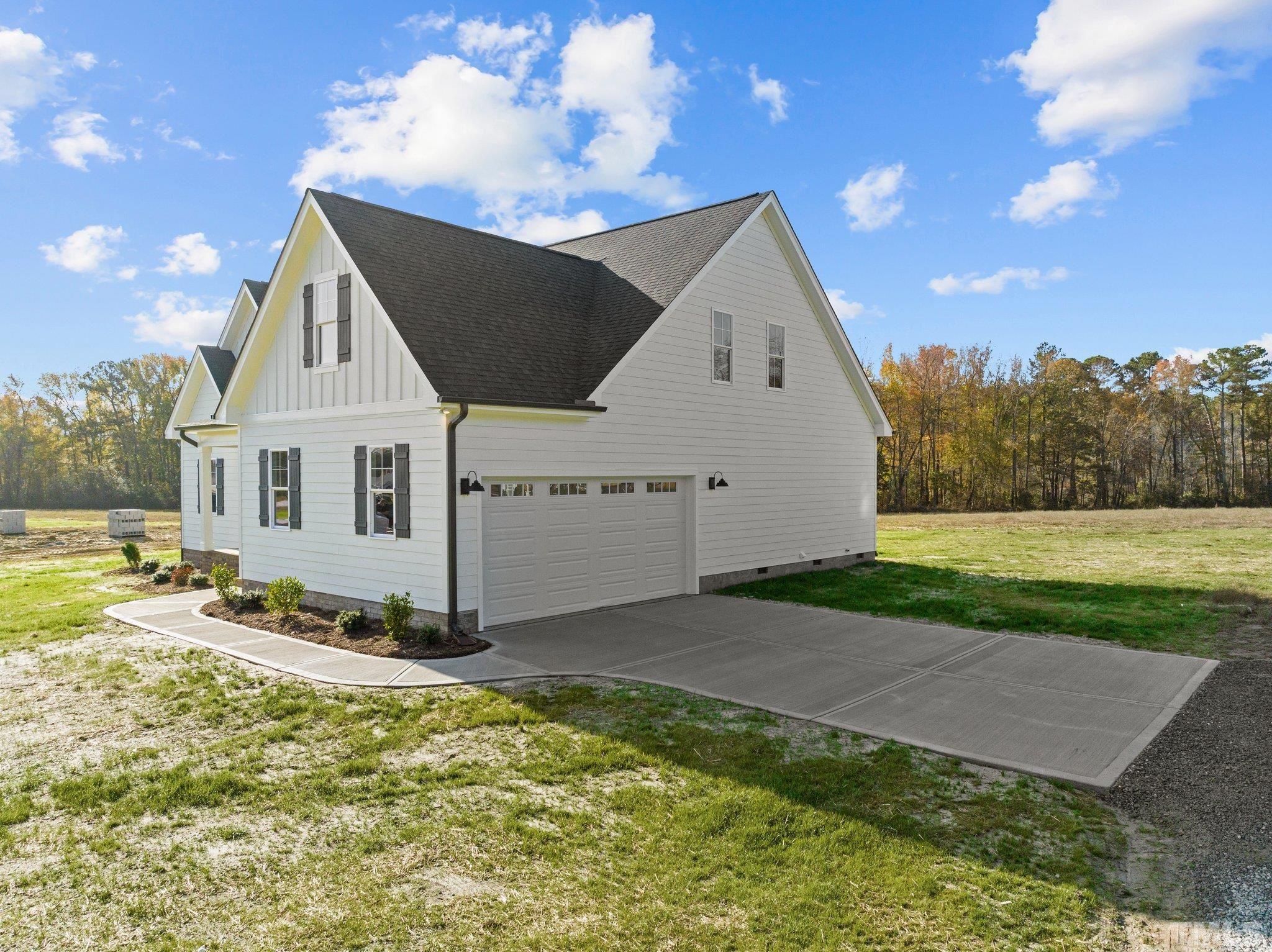 454 Pine Ridge Road Zebulon, NC 27597 - Photo 33 of 42 a view of a white house with a yard