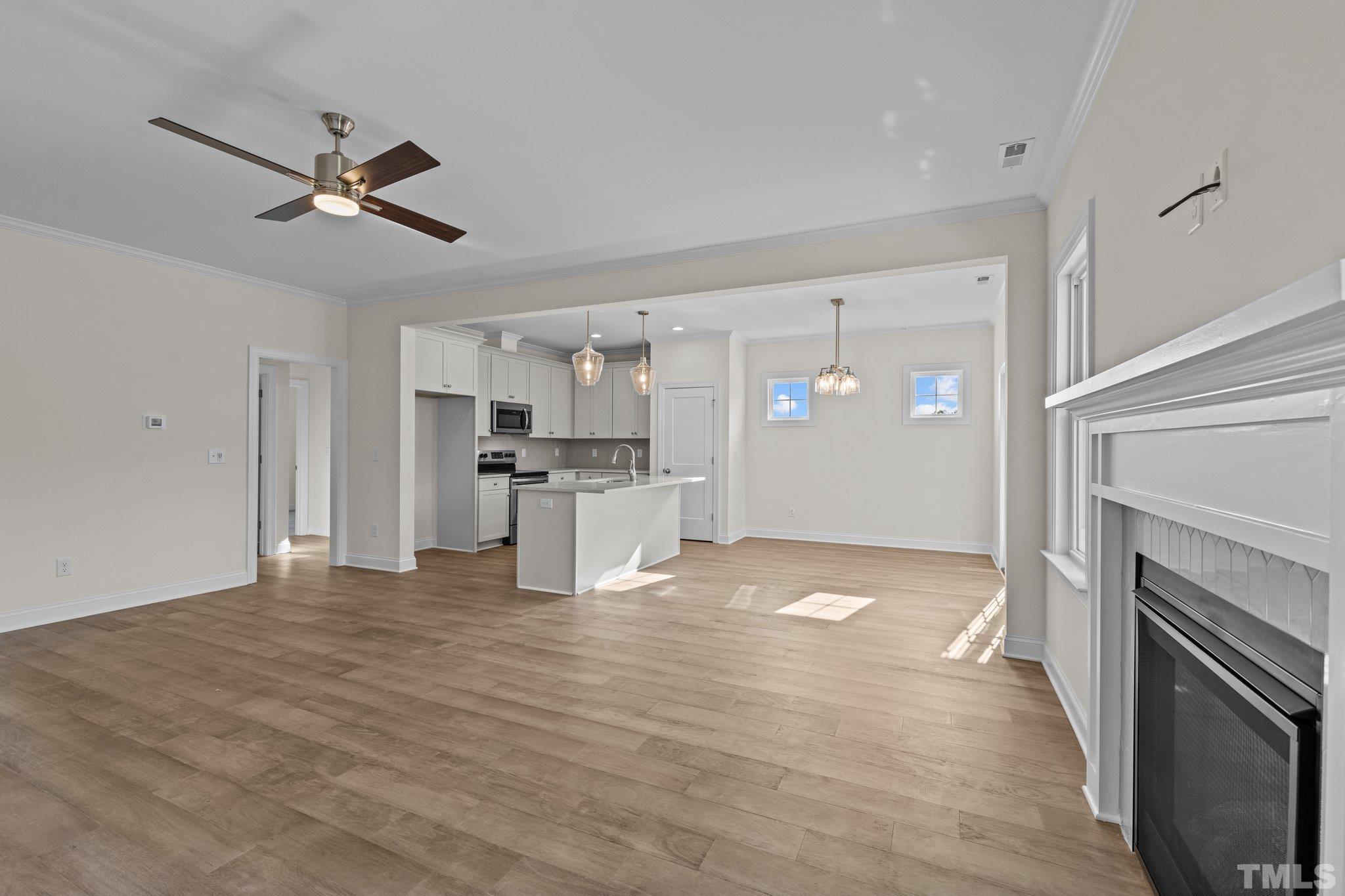 454 Pine Ridge Road Zebulon, NC 27597 - Photo 8 of 42 a view of a kitchen with a stove cabinets and wooden floor
