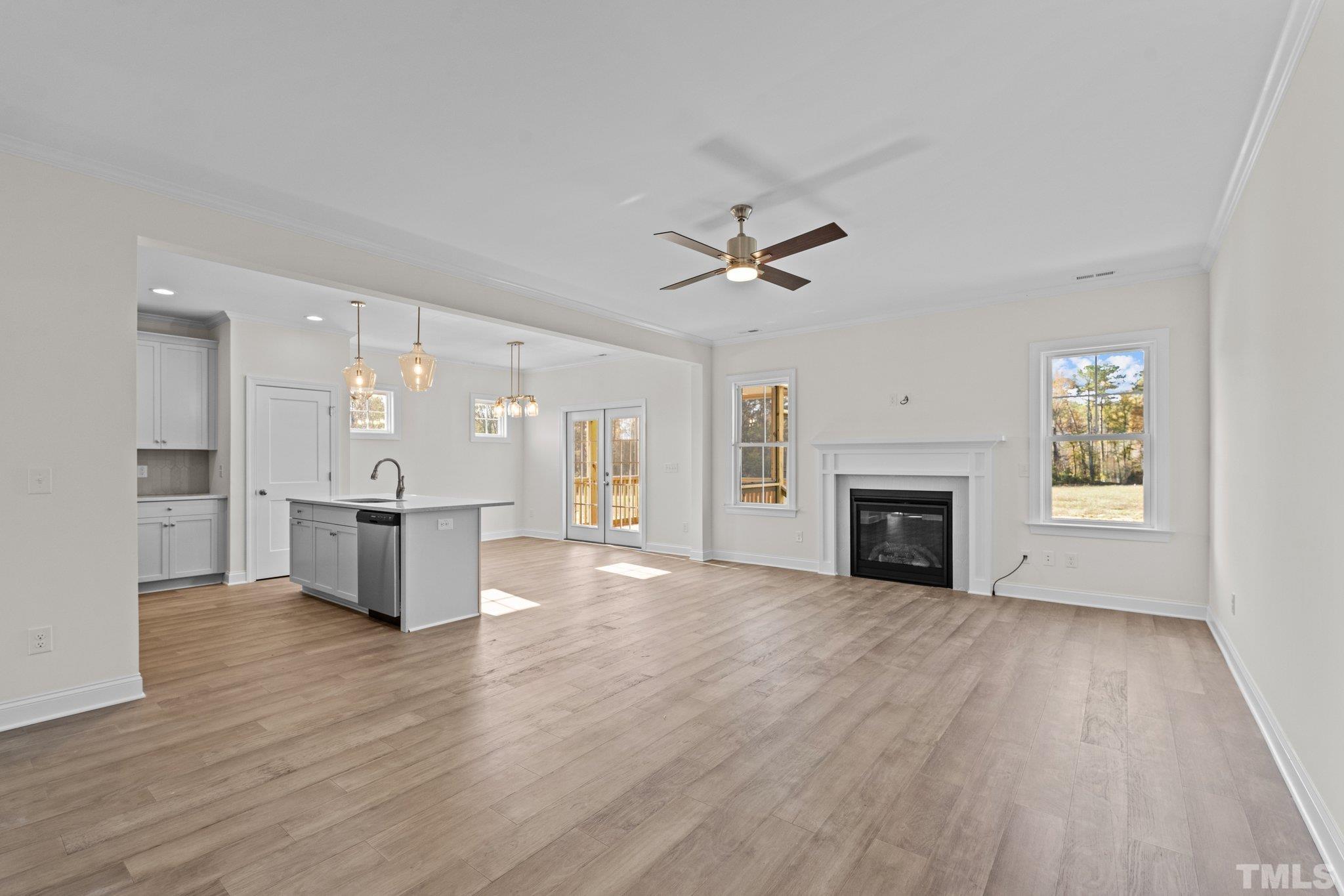 454 Pine Ridge Road Zebulon, NC 27597 - Photo 10 of 42 a view of a room with wooden floor and a kitchen