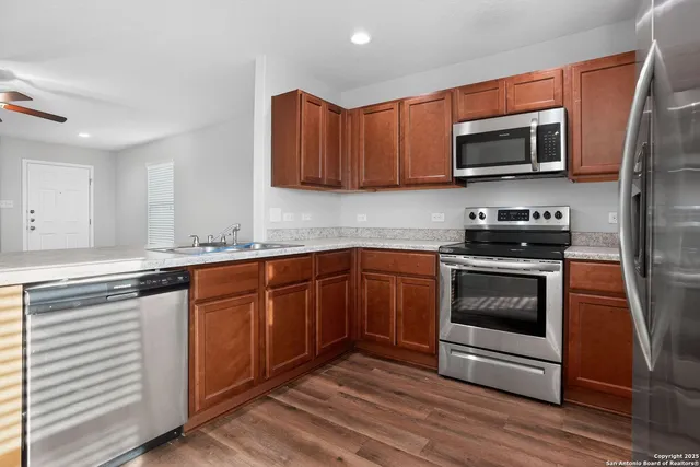 a kitchen with granite countertop a sink and steel appliances