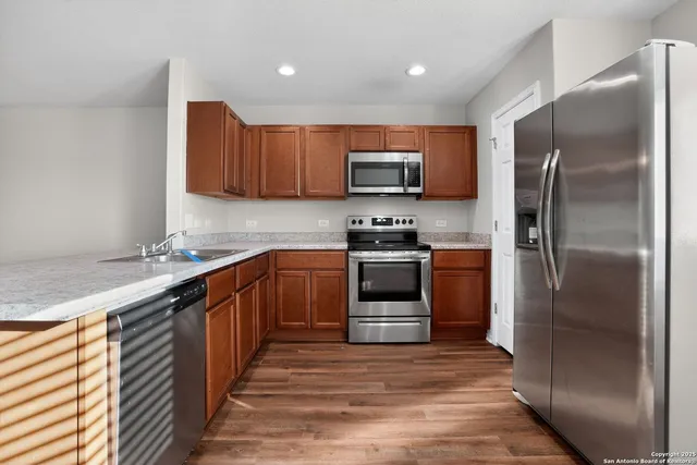 a kitchen with stainless steel appliances and a kitchen island