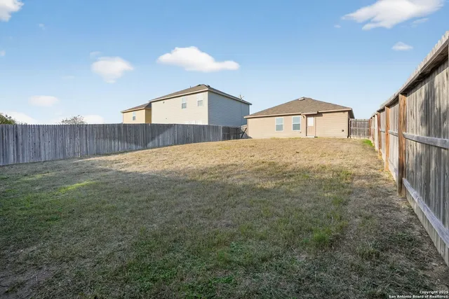 a view of a back yard of the house