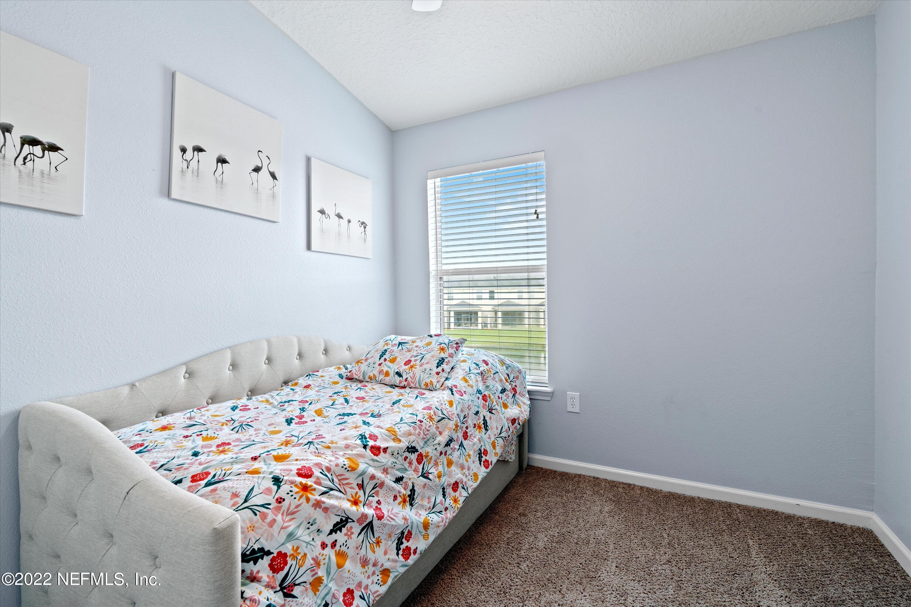 12970 Spring Rain Road Jacksonville, FL 32258 - Photo 21 of 30 a bedroom with a bed and a window