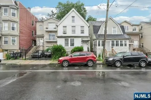 a view of a car is parked in front of a brick house