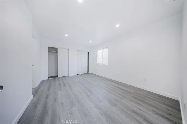 a bathroom with a sink a toilet a mirror and shower