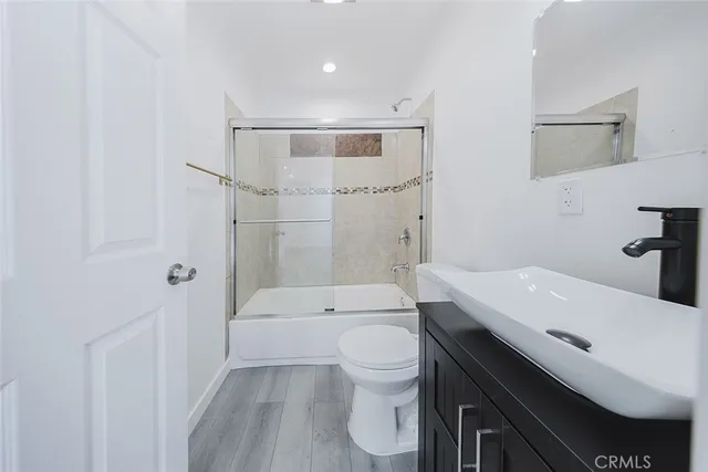 a view of a room with wooden floor and window