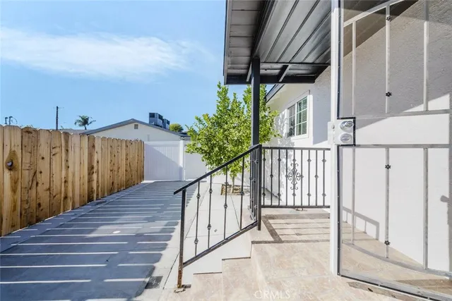 a view of balcony with wooden floor and fence