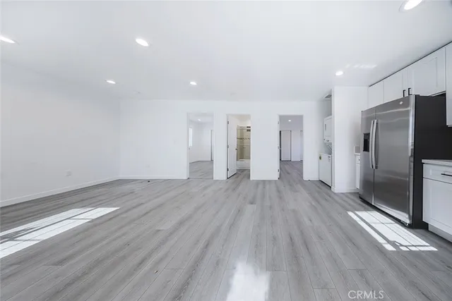 a kitchen with stainless steel appliances a refrigerator and a stove top oven