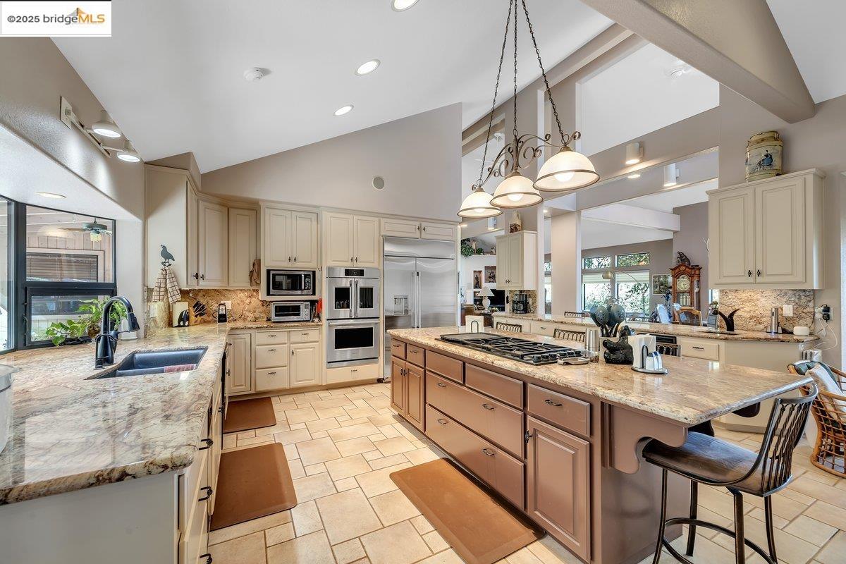 13700 Clements Road Groveland, CA 95321 - Photo 12 of 58 a kitchen with sink cabinets and dining table