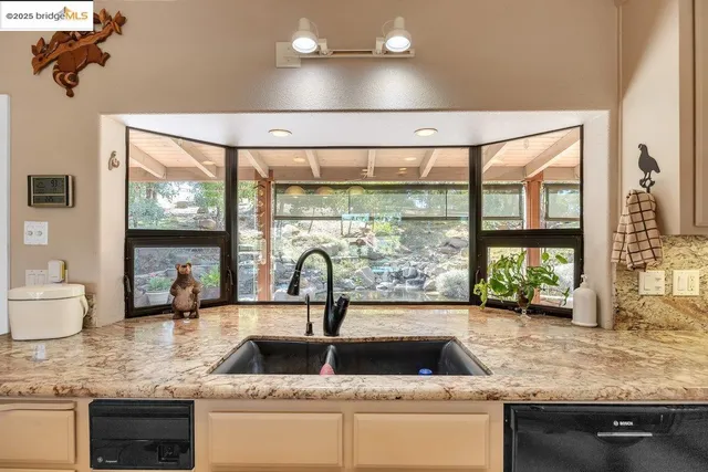a dining room with furniture and large windows