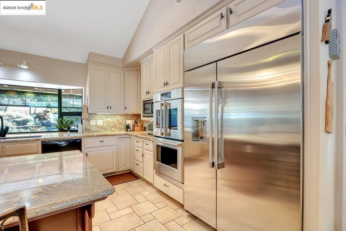 13700 Clements Road Groveland, CA 95321 - Photo 15 of 58 a kitchen with kitchen island a counter top space appliances and a cabinets