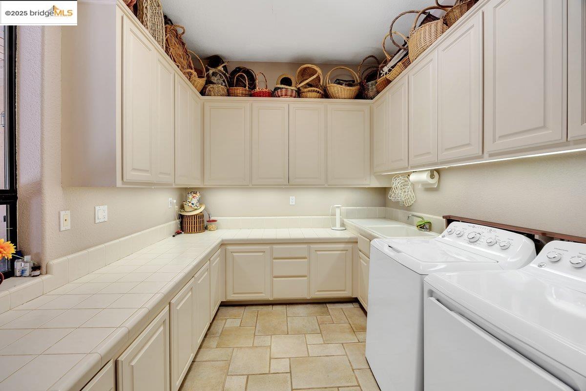 13700 Clements Road Groveland, CA 95321 - Photo 23 of 58 Laundry room featuring cabinet space and washer and dryer