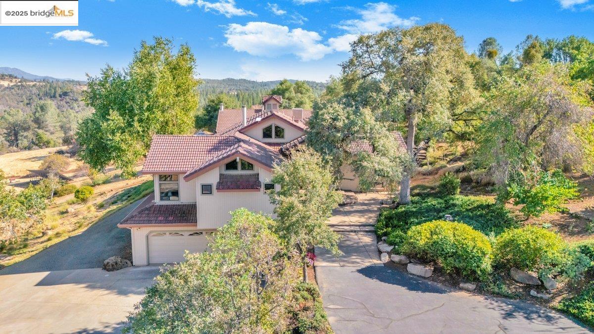 13700 Clements Road Groveland, CA 95321 - Photo 3 of 58 View of front of house featuring a tile roof, stucco siding, an attached garage, and concrete driveway