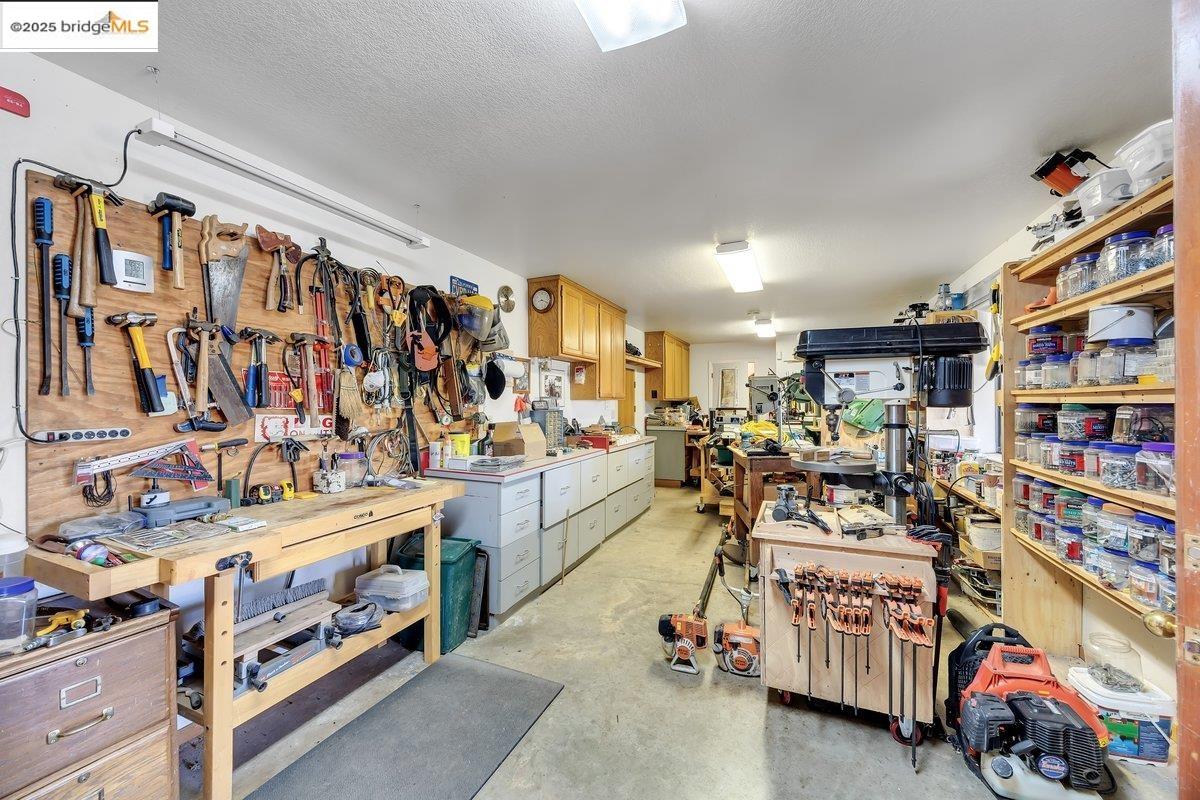 13700 Clements Road Groveland, CA 95321 - Photo 44 of 58 a storage room with washer and lots of white walls