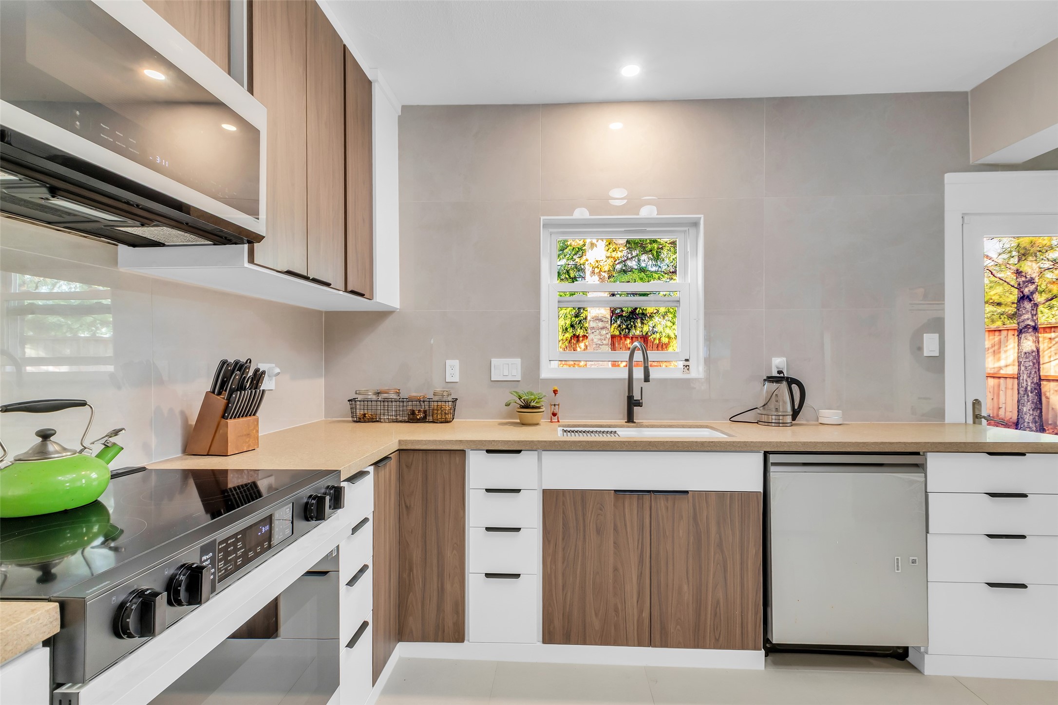 1831 Palm Street Houston, TX 77004 - Photo 14 of 26 The kitchen is equipped with stainless steel appliances, combining modern functionality with a clean, streamlined look for everyday cooking and entertaining.