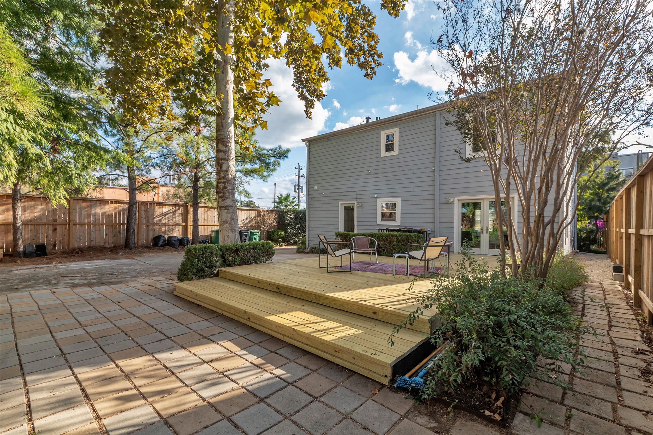 1831 Palm Street Houston, TX 77004 - Photo 25 of 26 The backyard is fully enclosed with a tall wooden fence, providing privacy and a secure area for outdoor activities.