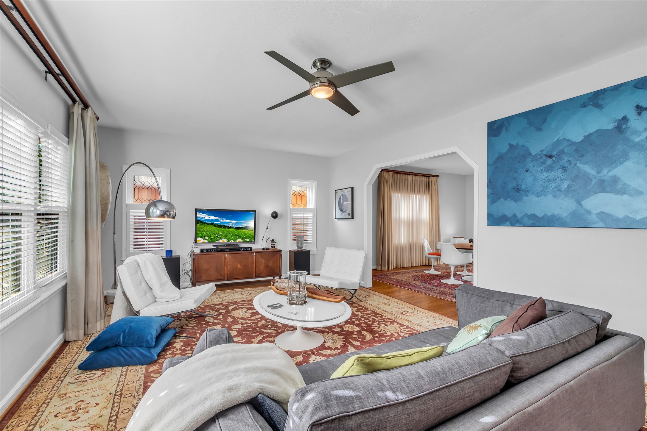 1831 Palm Street Houston, TX 77004 - Photo 6 of 26 This view of the living room showcases its seamless flow into the dining area, creating an open and inviting space ideal for entertaining and everyday living.