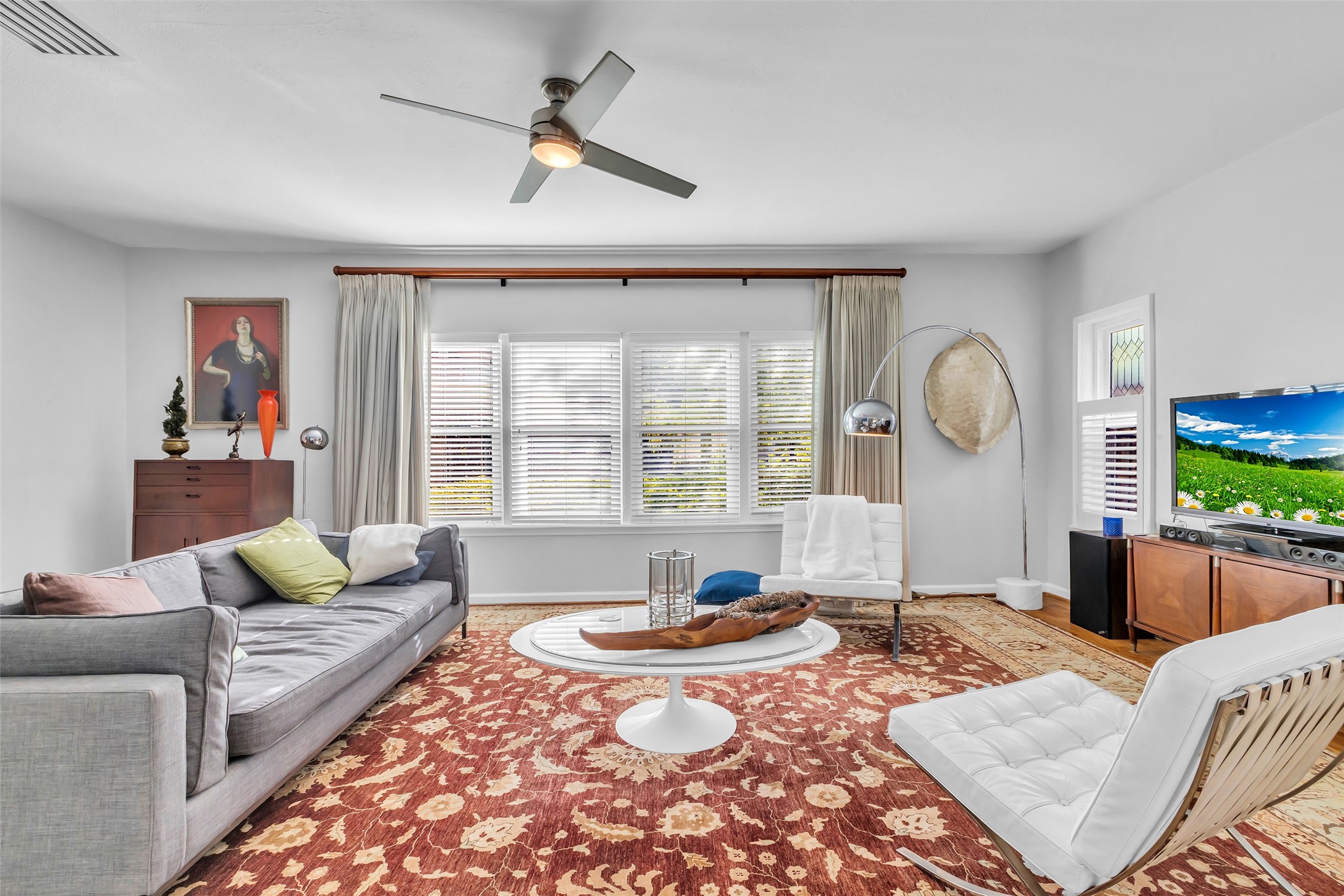 1831 Palm Street Houston, TX 77004 - Photo 8 of 26 Another view of the living room highlights its generous size and large windows that fill the space with natural light.