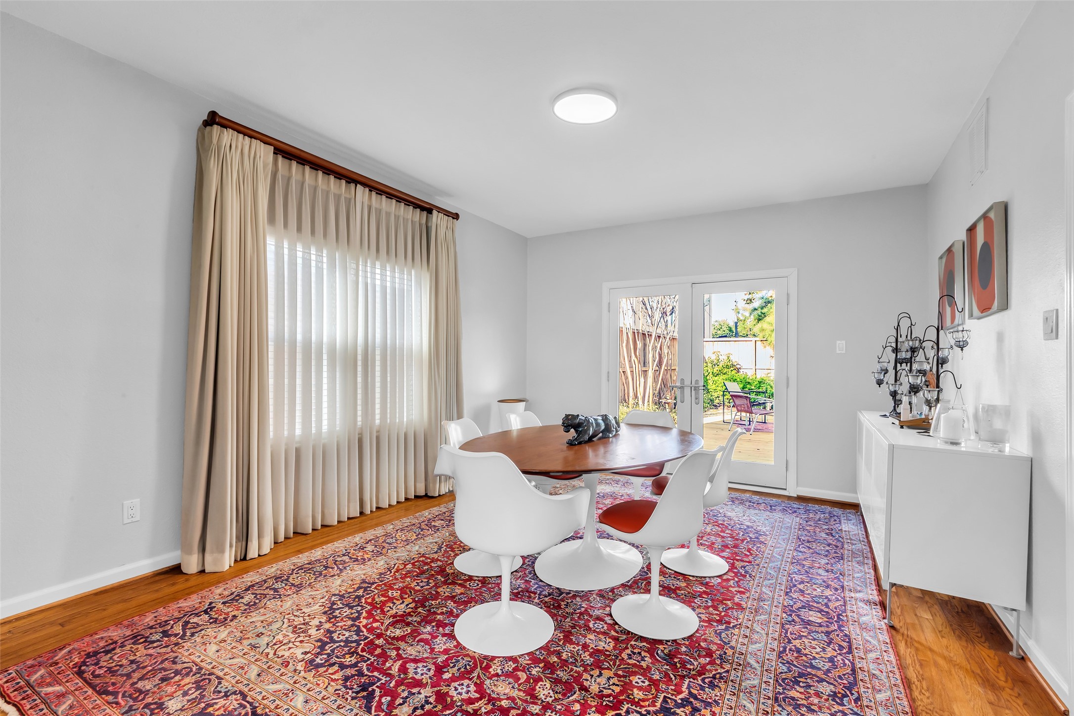 1831 Palm Street Houston, TX 77004 - Photo 10 of 26 The dining room is spacious and bright, featuring double glass doors that open directly to the backyard—perfect for indoor-outdoor dining and gatherings.