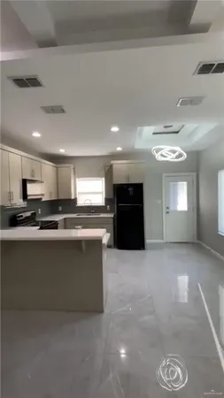 a large kitchen with stainless steel appliances granite countertop a sink and a stove