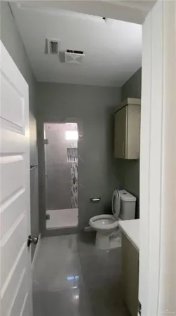 a bathroom with a granite countertop sink mirror and toilet