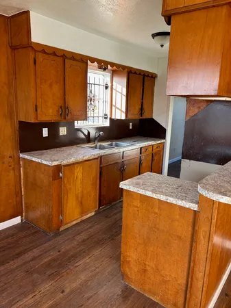 a kitchen with wooden cabinets and sink
